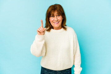 Senior caucasian woman isolated showing number one with finger.