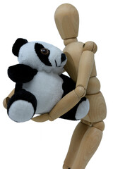 On a white background, a small wooden mannequin holds a puppet in his arms depicting a panda bear, a world symbol for the protection of animals and nature
