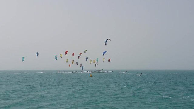 Kite surfers in the water on Dubai beach