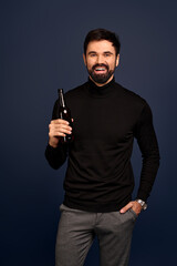 Photo of amazing guy with brown beer ale bottle spending great time wear trendy sweater isolated on Pacific Blue background