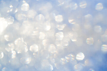 Blurred sunlight overlay effect. Rainbow rays of light on a blue sky background. Natural bokeh...