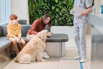 Owners with dog at vet clinic
