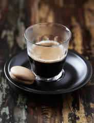 Coffee in glass cup on rustic wooden background. Close up.	