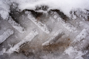 the tramline of the tractor tires is visible on wet ice