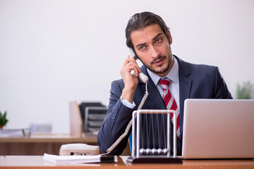 Young man businessman employee sitting in the office