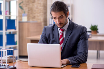 Fototapeta premium Young man businessman employee sitting in the office