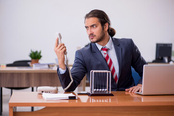 Young man businessman employee sitting in the office