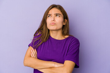 Obraz premium Young skinny caucasian girl teenager on purple background tired of a repetitive task.