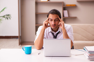 Young male employee working from home during pandemic