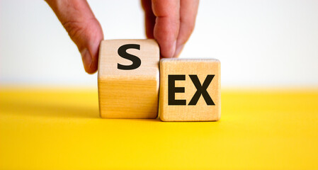 Sex with an Ex symbol. Hand turns a cube and changes the word 'ex' to 'sex'. Beautiful yellow...