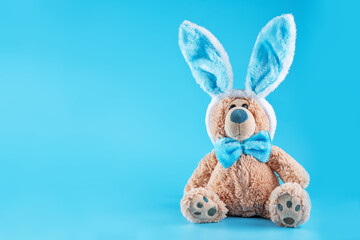 Blue background with toy bunny for Easter