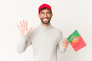 Young hispanic mixed race woman holding a portugal flag smiling cheerful showing number five with fingers.