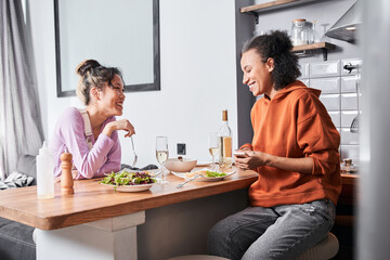 Friends sitting at the bar counter and laughing