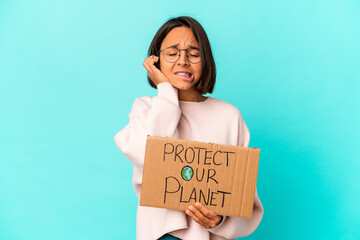 Fototapeta na wymiar Young hispanic mixed race woman holding a protect our planet cardboard covering ears with hands.
