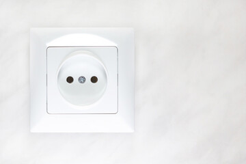 White socket on a light background electricity in the house selective focus