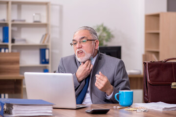 Coronavirus infected old businessman employee sitting in the off