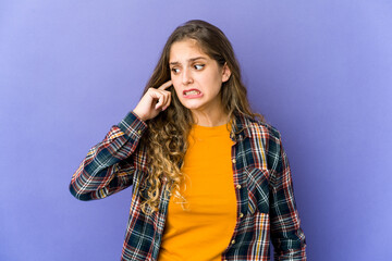 Young caucasian cute woman covering ears with hands.