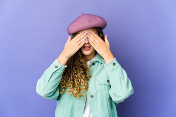 Young caucasian cute woman afraid covering eyes with hands.