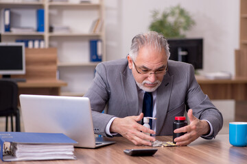 Coronavirus infected old businessman employee sitting in the off