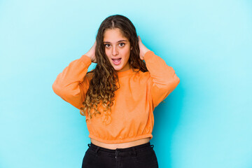 Young caucasian curly hair woman isolated screaming, very excited, passionate, satisfied with something.
