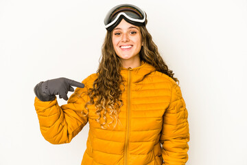 Young caucasian snowboarder woman isolated person pointing by hand to a shirt copy space, proud and confident
