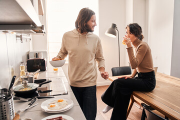 Young couple cooking together in the kitchen at home