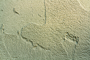 rough plaster facade painted yellow as a texture or background