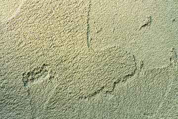 rough plaster facade painted yellow as a texture or background
