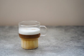 A cup of coffee on a table. gray background