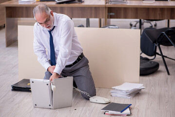 Old businessman employee in bankruptcy concept in the office