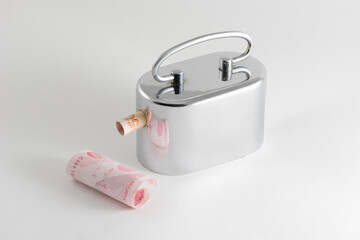 Metallic money box and Turkish Lira banknotes.