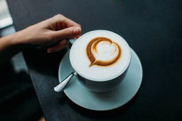 cup of coffee with a foam in the form of a heart. Coffee with foam.