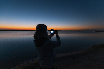 silhouette of a person watching the sunset