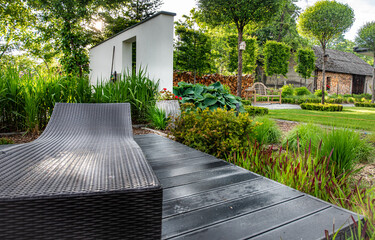 
A relaxing spot for a warm, summer day - a stylish, wooden terrace with wicker garden furniture,...