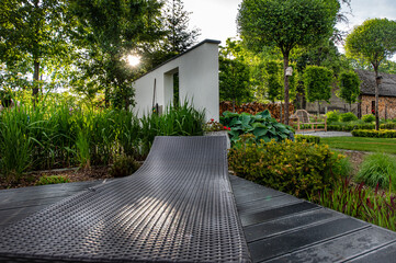 
A relaxing spot for a warm, summer day - a stylish, wooden terrace with wicker garden furniture,...