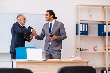 Two businessmen in the classroom in pandemic concept