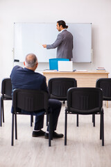 Two businessmen in the classroom in pandemic concept