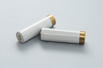 White AA Batteries on the gray background.