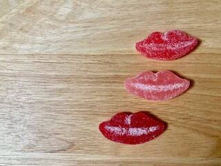 red valentine candy lips on wooden background