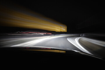 Fototapeta na wymiar Car driving through the Night 