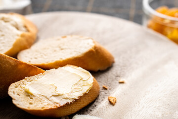 Bread and butter for homemade breakfast with coffee tea milk and organic slide whole wheat rye grain flour brown French  baguette with bio marmalade jam mix with orange passion fruit apricot