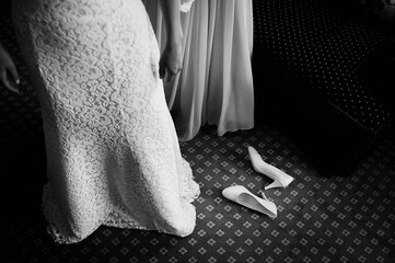 Bride in dress, shoes on the floor. bride is dressed.