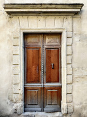 Fototapeta na wymiar Wooden brown vintage door in the old stone building.