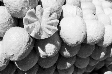 Fototapeta na wymiar Group of piled guavas with one of the fruits opened in a decorative way. [Black and White version] 