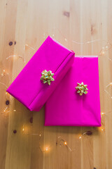 couple of birthday present wrapped up in pink and gold on wooden table, parties and celebrations