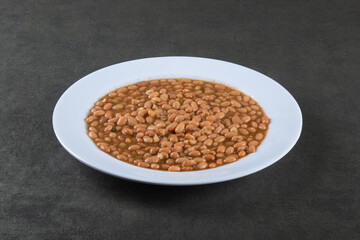 Food plate with beans isolated on dark background