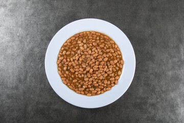 Food plate with beans isolated on dark background top view