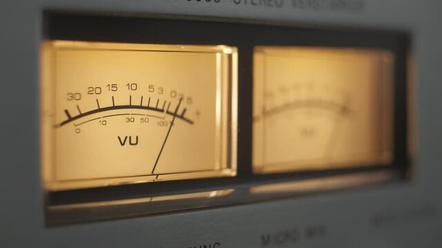 Audio signal levels monitoring audio console on classic sound amplifier. Close-up analog signal indicator with arrow