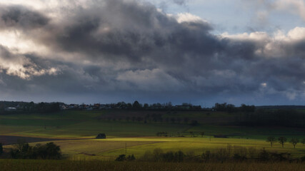 German landscape in Eifel with fields and a small barn on sunny winter day in golden sunlight