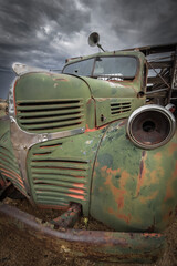 Fototapeta premium Old abandoned rusty truck with cloudy sky background